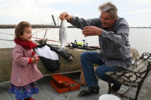 Grandfather fishing with girl